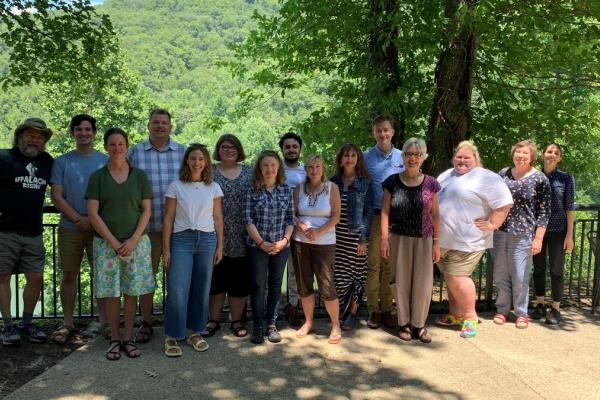 Outside members of the community university team assemble for a research and planning retreat.