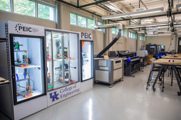 Room with 3D printers in a display case